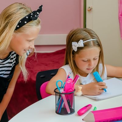 Caucasian girl wathching her younger sister drawing with marker. Family relations