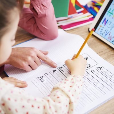 Close up of mother helping her child with homework