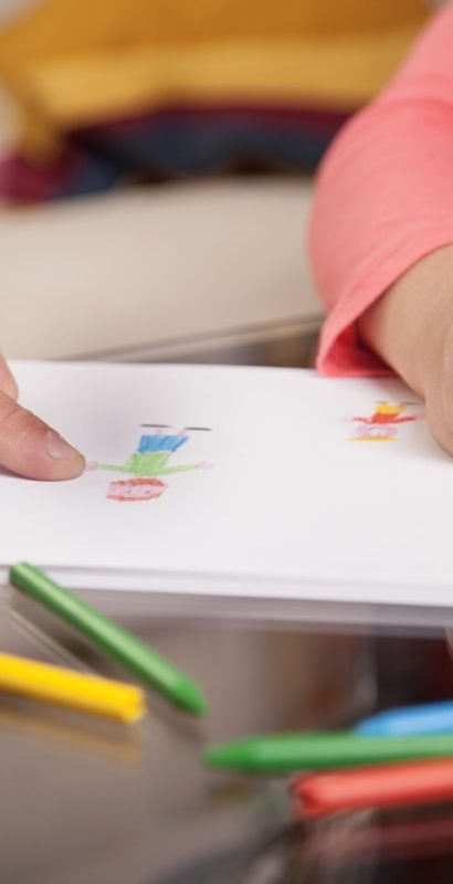 close-up-girl-drawing-her-father-pointing